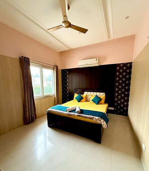 Modern farmhouse bedroom with stylish decor and comfortable bed at Golden Venue.